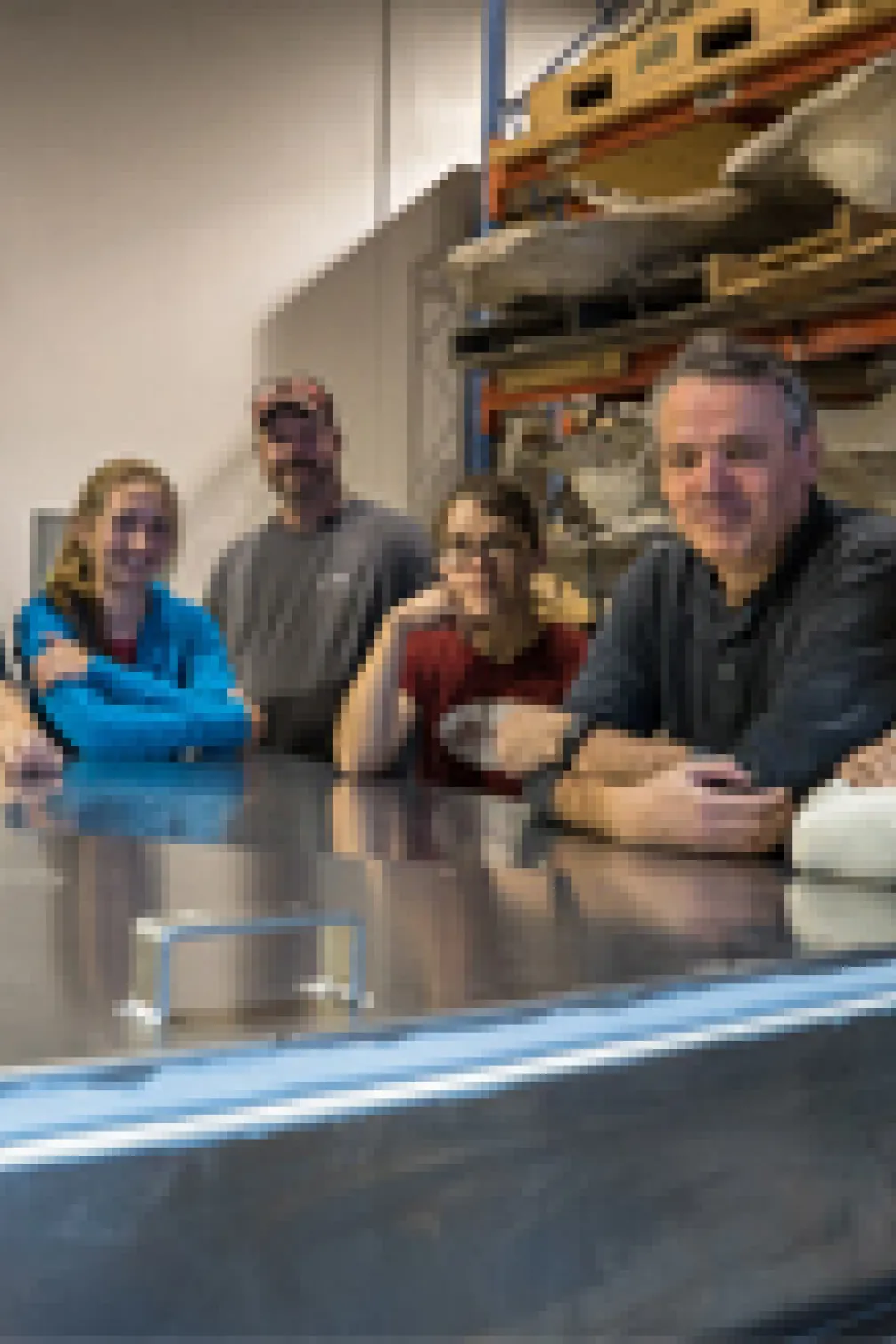 ROM's Blue Whale team pose beside the shipping container holding the blue whale heart.
