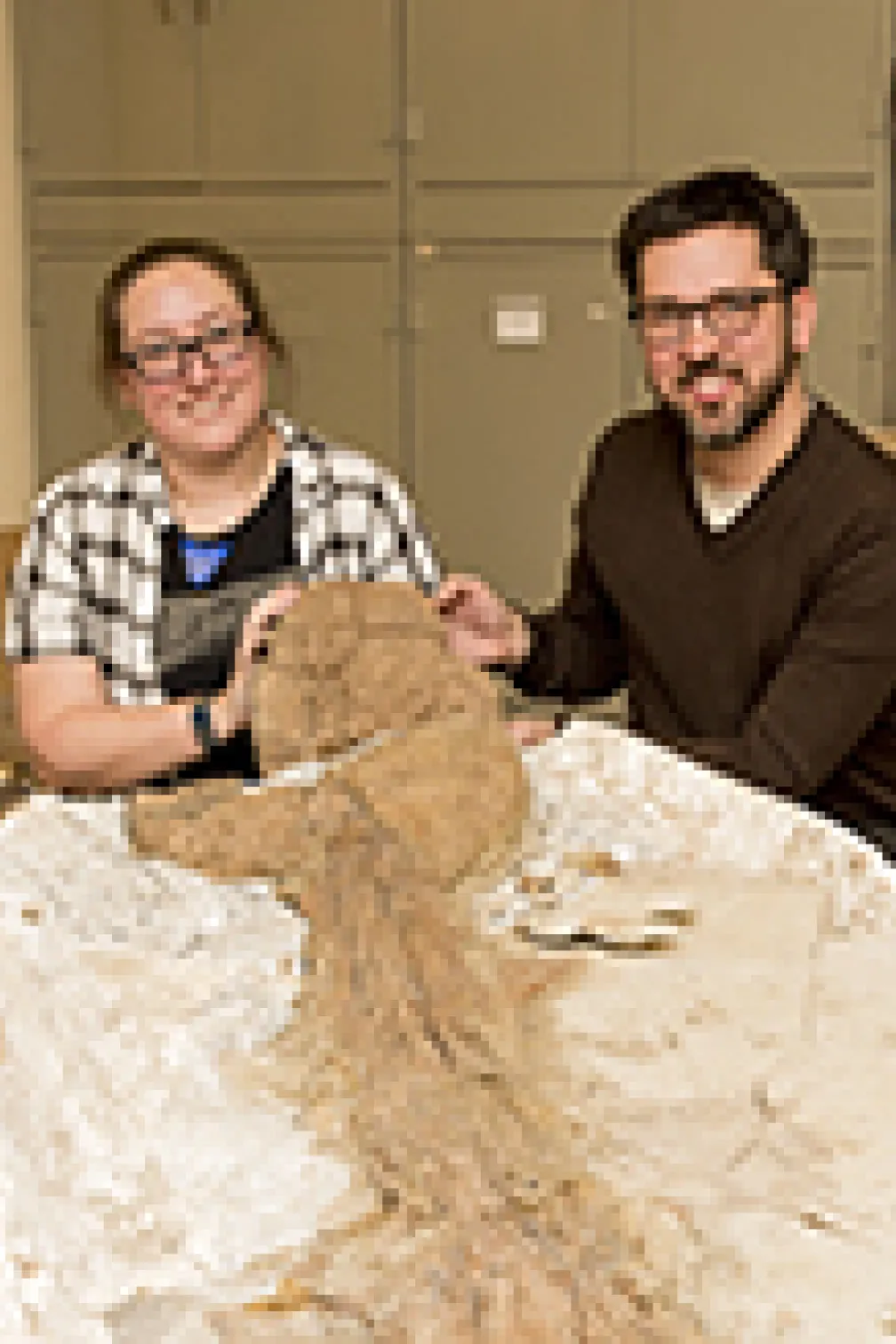 Photo of two people with a fossil
