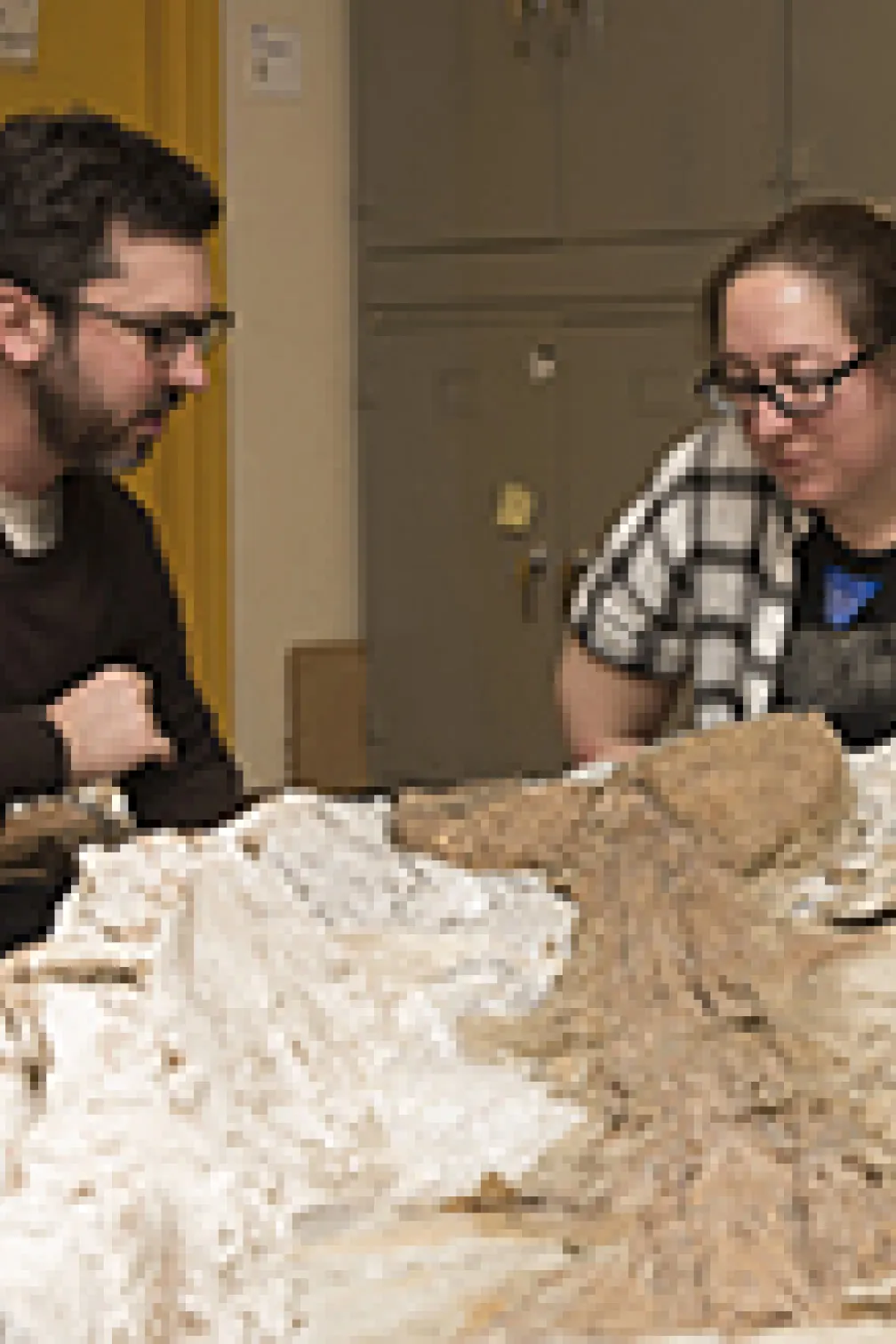 Photo of two peope with a fossil
