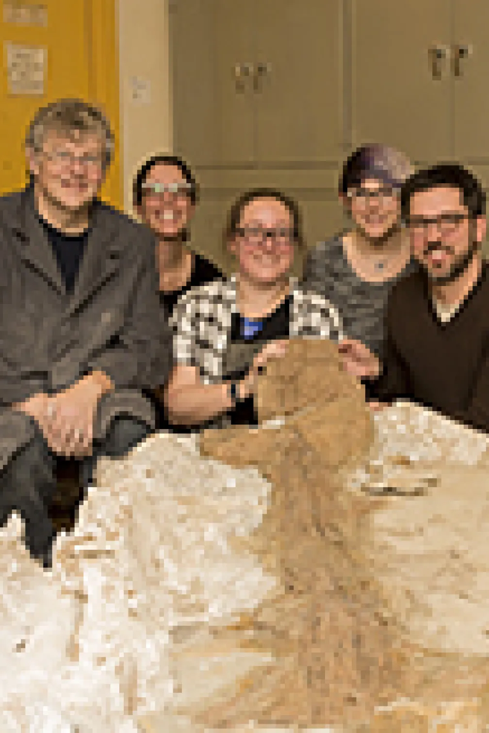 Photo of five people behind the tail specimen
