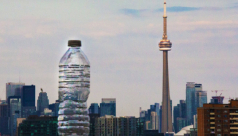 A photo of the skyline where a plastic water bottle stands next to Toronto’s CN Tower. Photo credit: Cristina Bergman