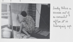 "Judy takes a crease out of a coverlet after it is hanging up."