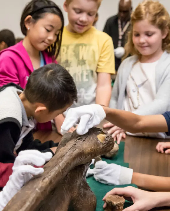 Kids with fossil bone
