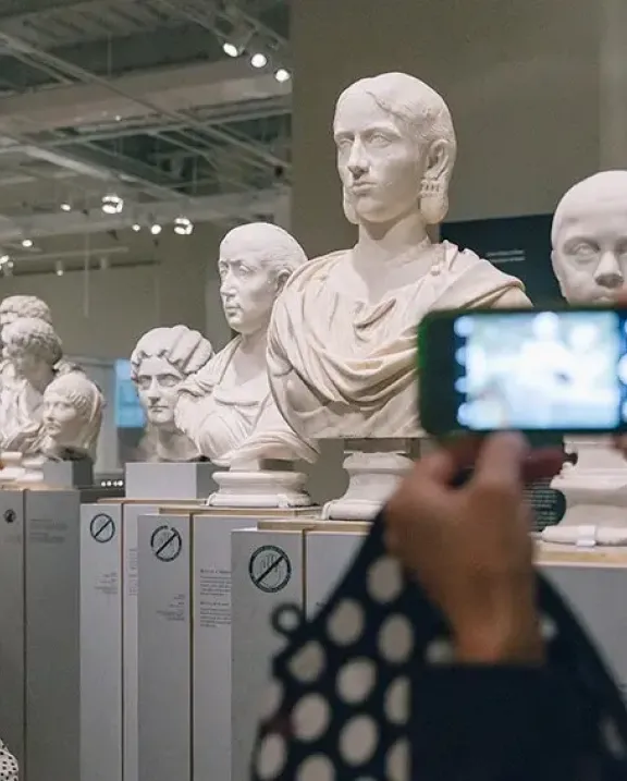 Guest taking a photo of sculptures at ROM