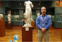 a man and a cartoon turtle stand in front of a statue of Aphrodite