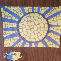  Mosaic of a sun made from yellow, blue, and black squares.