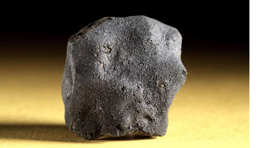 the tagish lake meteorite against a yellow and black background
