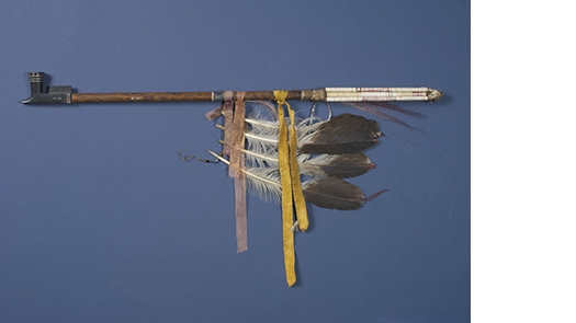 photo of a pipe decorated with eagle feathers