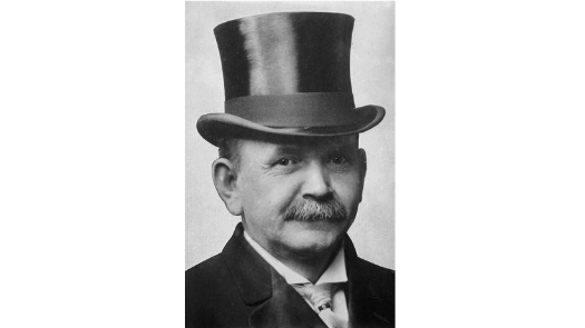 a black and white photo of a man wearing a top hat