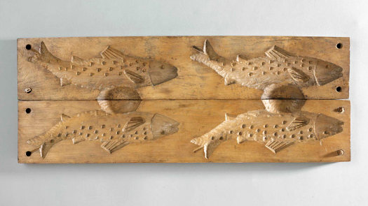a wooden mould in the shape of a fish