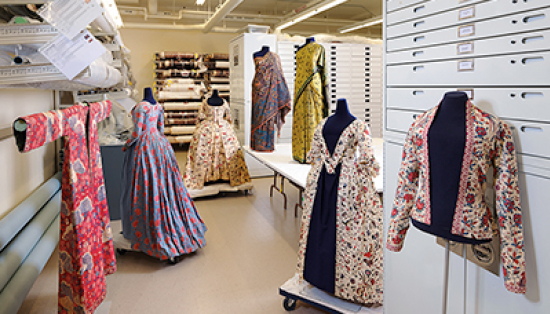 Chintz dresses on mannequins in museum storage area.
