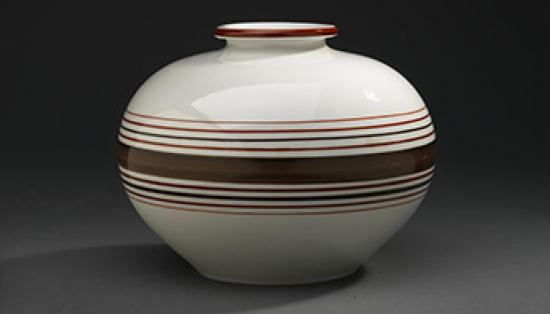 A porcelain vase with brown stripes.