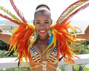 A lady wearing bright orange feathers.
