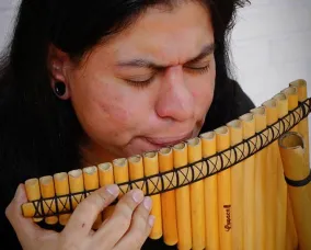 A woman playing a pan flute.