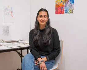 Russna Kaur sitting on a chair posing for photo