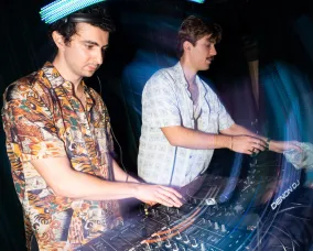 Fisheye shot of DJ Alto and Bili performing.