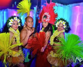 Four people dressed in Hawaiian attire.