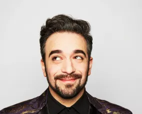 Headshot of a young man with short dark hair and beard.