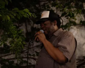 Donovan Locke holding a microphone.