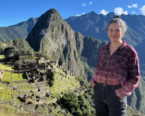 A woman with light hair visiting Machu Picchu in Peru.