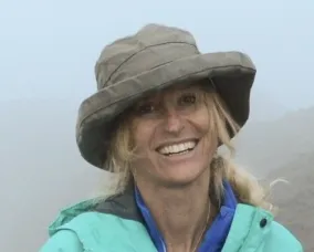 A woman with blonde hair wearing a hat.
