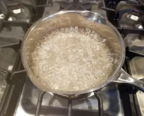 Pot with the sugar water boiling