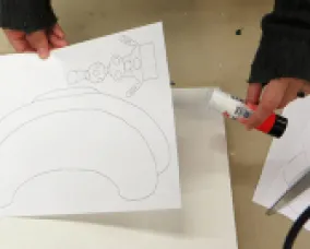 hands glue the template to card stock