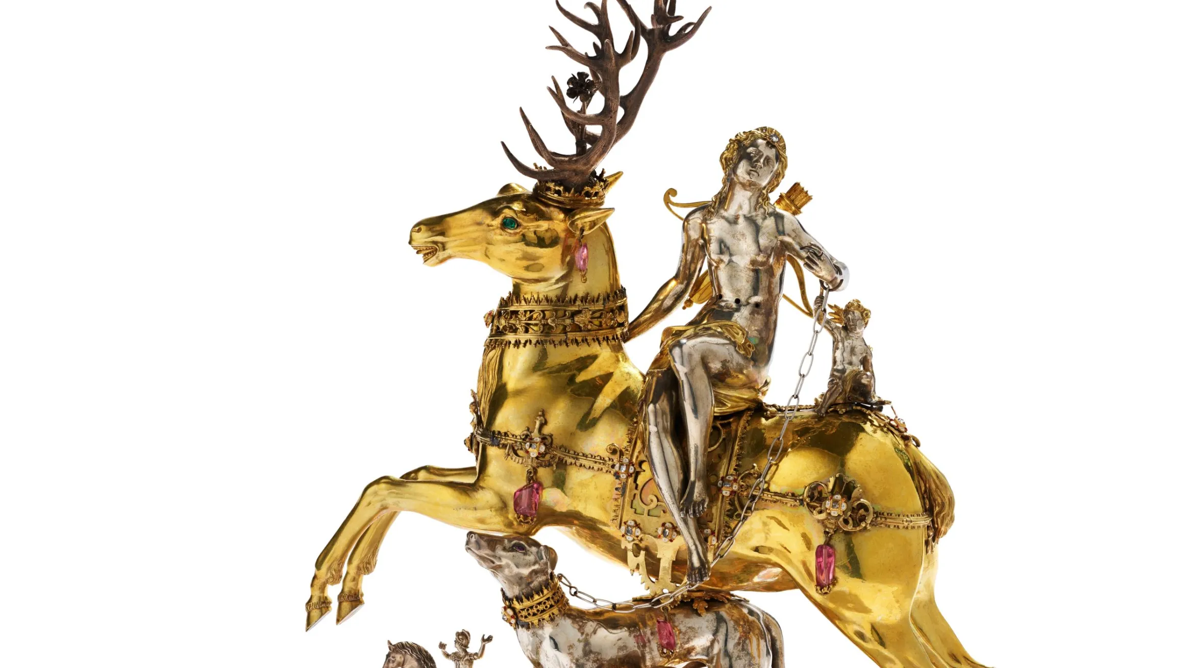A silver woman sits on top of a golden stag, below her are dogs and another person riding a horse.