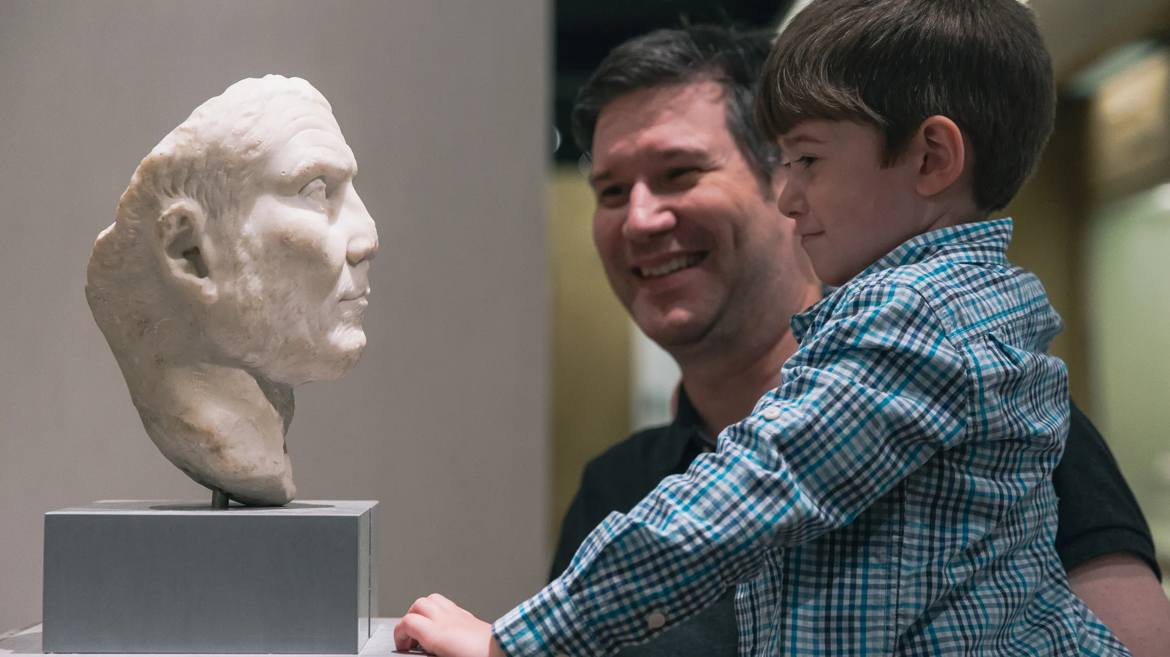 Father and son enjoying ROM sculpture