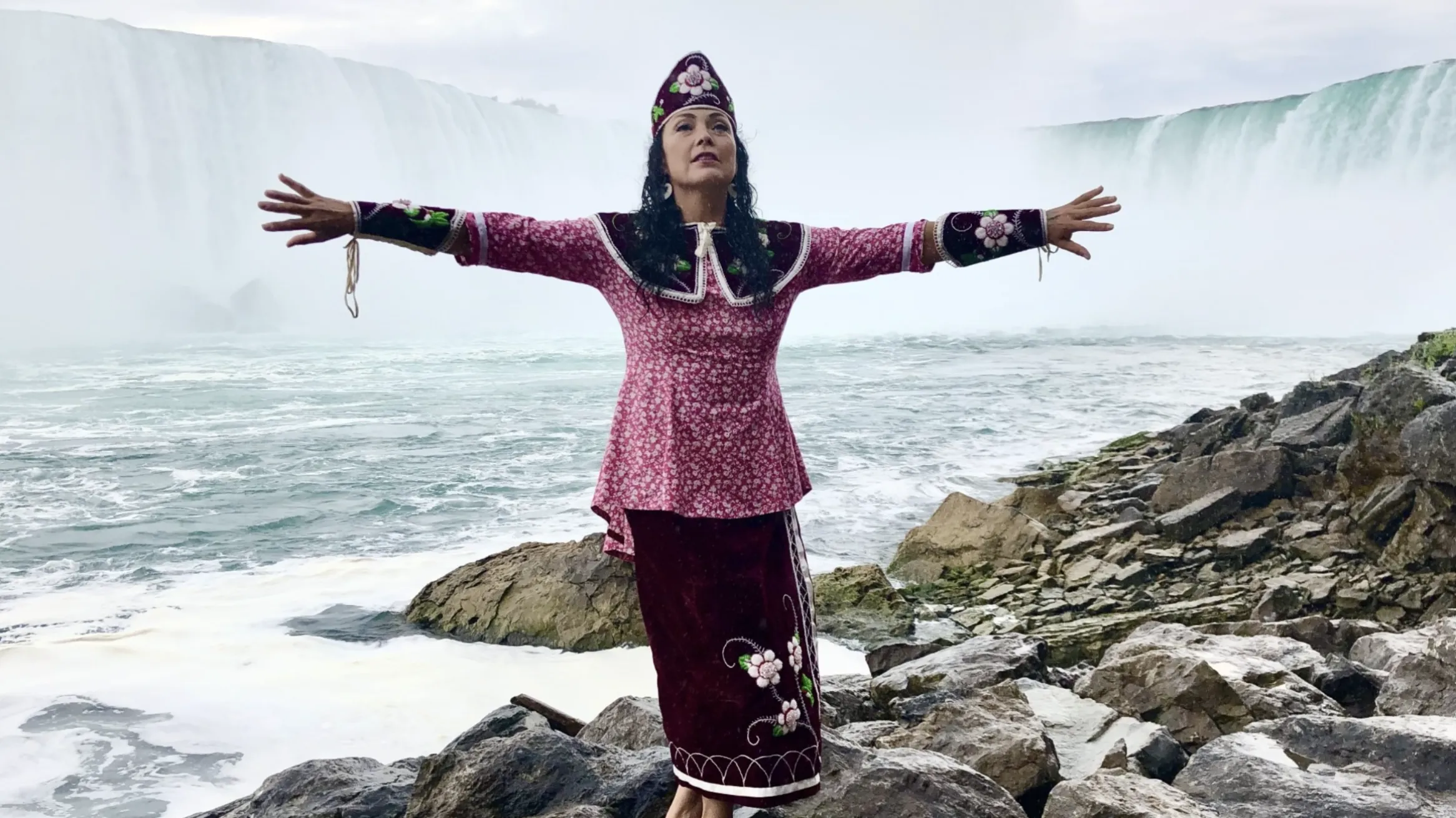 Indigenous lady standing by falls located in Santee 