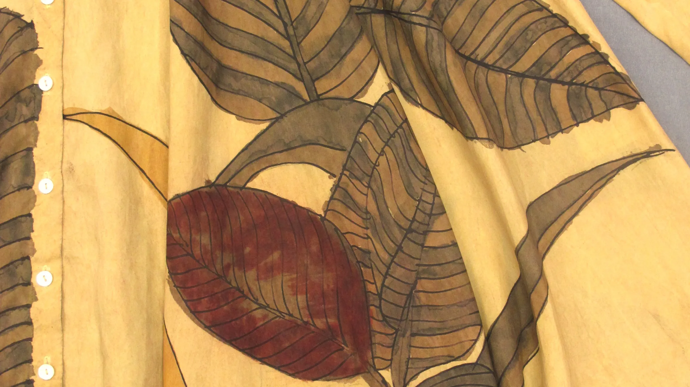 Leaves stitched on to a yellow blanket.