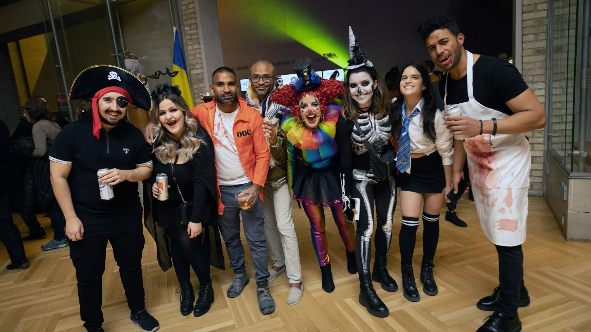 A group of people in Halloween costumes in the museum.