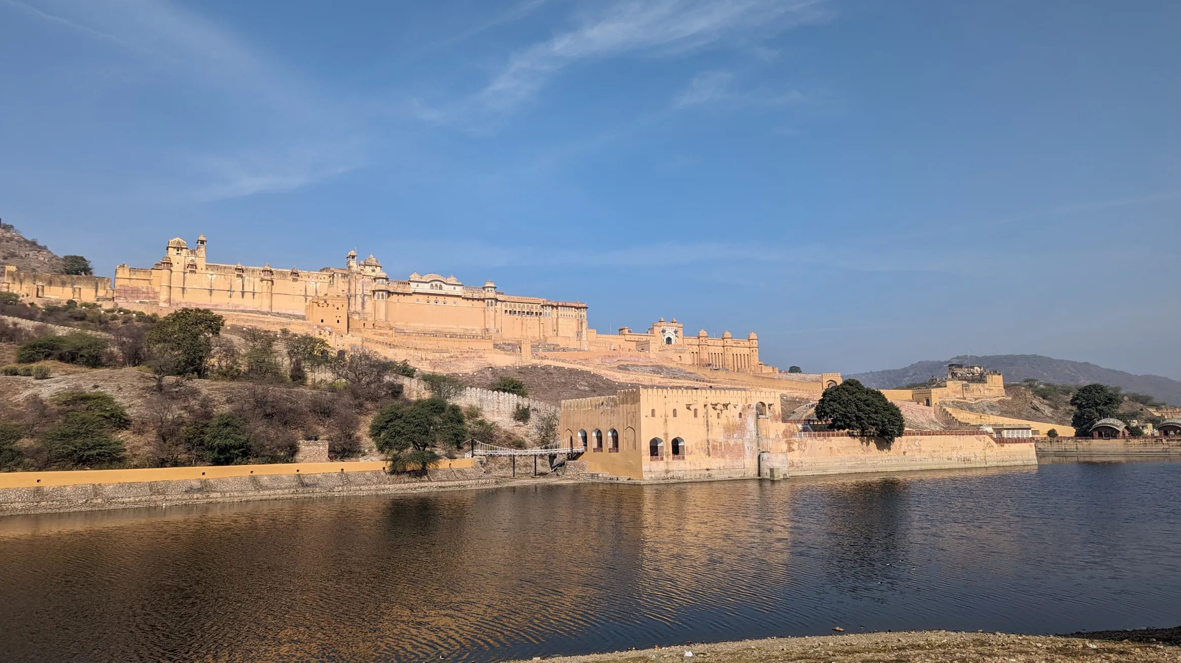 Amber Fort, Jaipur, India. © Noon Plastic, 2024.  Alt text: A fort on the banks of a lake.