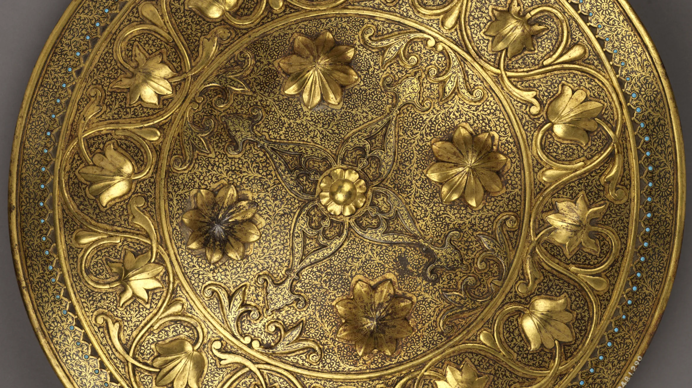 Mughal Empire, 18th - 19th century CE, gold shield with ring of inlaid turquoise gems.