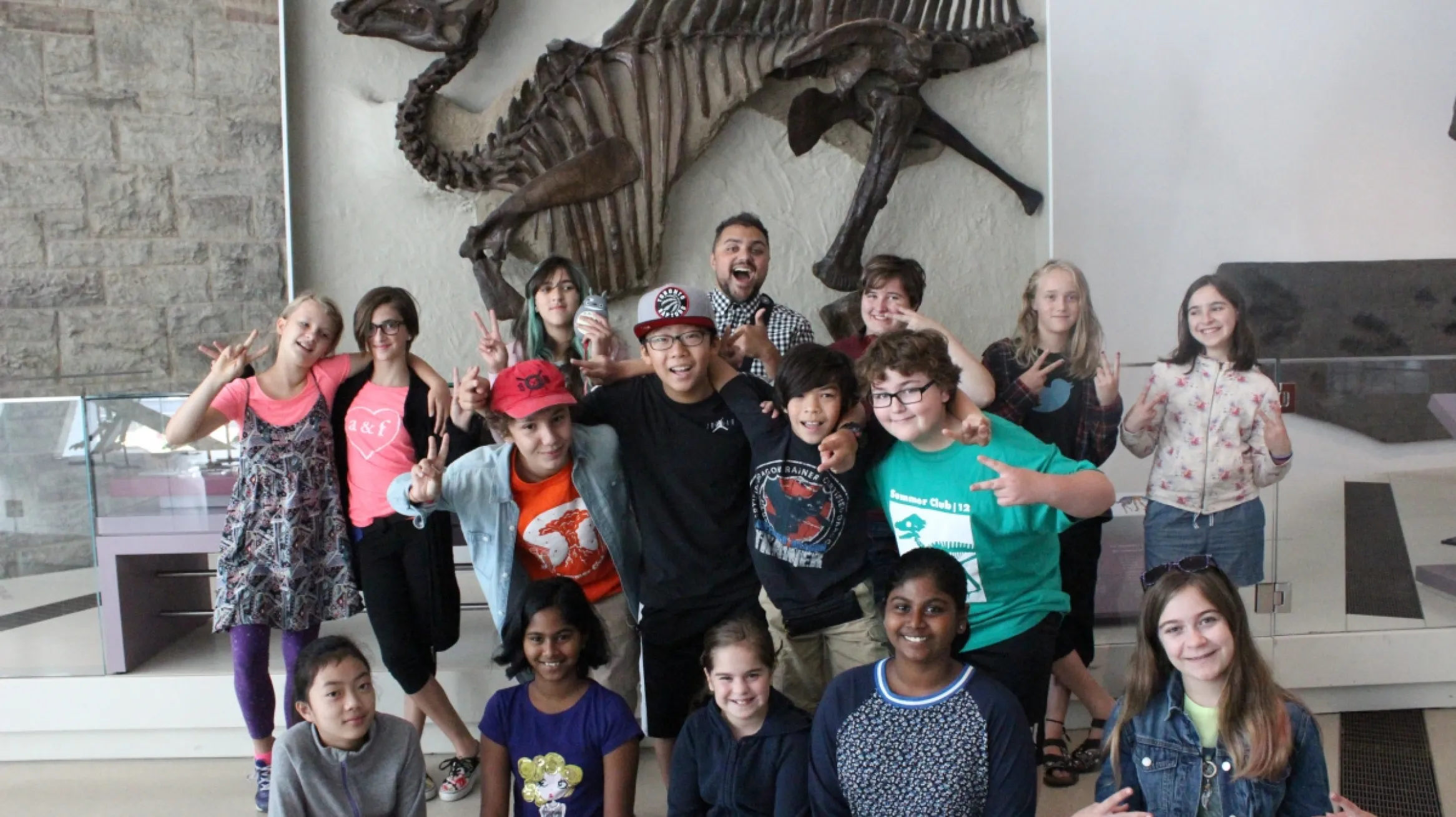 ROM kids volunteers explore the Dinosaur Gallery.
